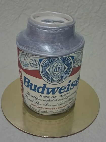 A hyper-realistic Budweiser beer can cake. This sculpted cake is a fun and surprising centerpiece for a beer lover's party.