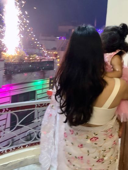 A picture from our Diwali celebration, watching the fireworks from our balcony. Holding her close during these moments is what makes festivals so special.