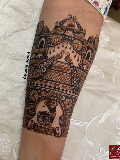 A royal bridal mehendi design featuring palace architecture, peacocks, and traditional wedding symbols like the dhol and kalash.