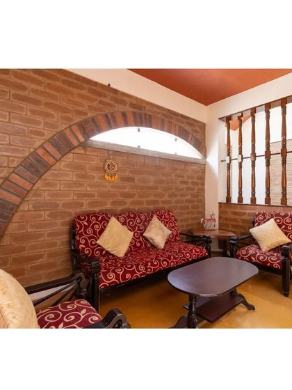 A brick arch gracefully frames a seating area, demonstrating how structural elements can also serve as beautiful decorative features.