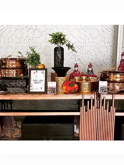 A clean and modern buffet setup using copper-toned chafing dishes and minimalist decor for a sophisticated look.