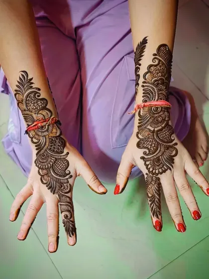 A stunning back-of-hand Arabic design, featuring a bold, flowing pattern that extends from the wrist to the index finger.