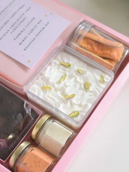 A peek inside my Rakhi hamper, showing the Tres Leches cake and savory dips.