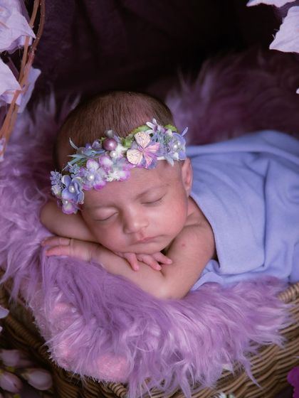Another angle of our purple floral tent, showing the baby nestled peacefully inside. The soft fur and layers of fabric create a cozy and safe space.