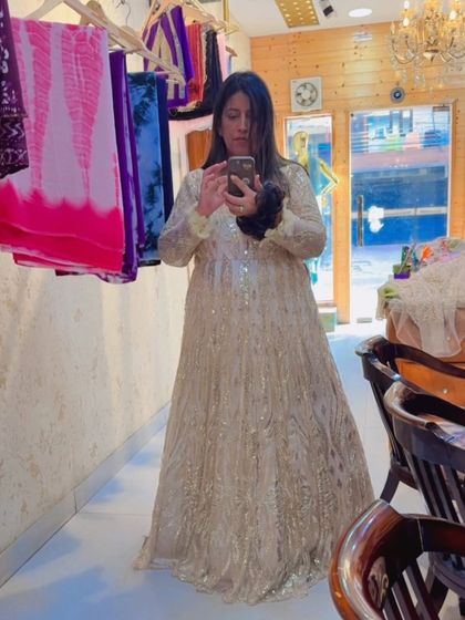 A mirror selfie showing off this gorgeous golden gown. It's a perfect example of being "never overdressed, just perfectly golden."