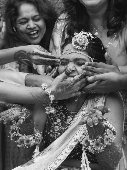 Overwhelmed with love and turmeric! A fun, chaotic, and absolutely unforgettable moment from a Haldi ceremony, captured in timeless black and white.