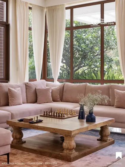 A cozy family living area in 'A Walk in the Clouds', featuring a large, comfortable L-shaped sofa and a rustic wooden coffee table, perfect for game nights.