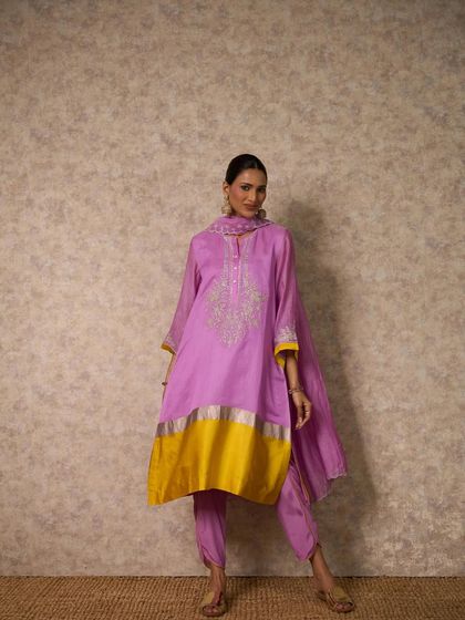 A beautiful lilac kurta set with a striking yellow and silver border, offering a unique and modern color palette.