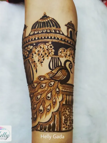 Another view of a peacock-themed arm piece, showing the bird perched in a jharokha. The detail in the architecture and the feathers is key.