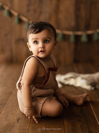 Capturing their cute little expressions forever. This baby is looking up with wonder, a perfect candid moment during the session.