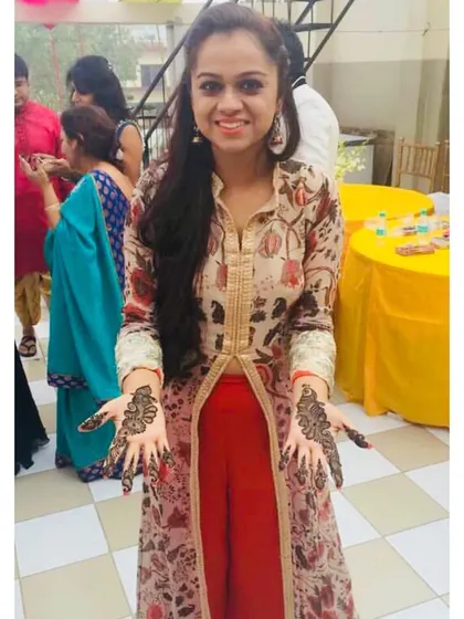 A perfect outfit for a Mehendi function, featuring a printed jacket-style kurta over bright red pants. This look is comfortable enough for all the festivities while still being incredibly stylish.