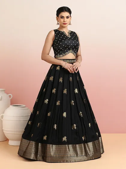 Inspired by the sacred art of Pichwai, this black pleated lehenga features delicate golden motifs of cows. The modern silhouette and traditional artistry make it a unique and sophisticated ensemble for festive nights and wedding receptions.
