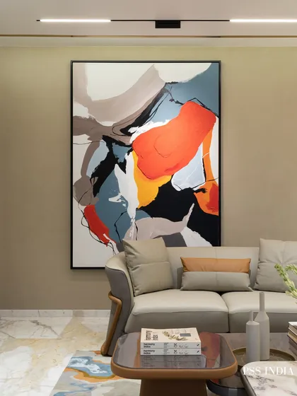 A large, dynamic abstract painting brings energy and color to this neutral living room. It’s the kind of piece that pulls you in, sparks conversation, and elevates the atmosphere from ordinary to extraordinary.