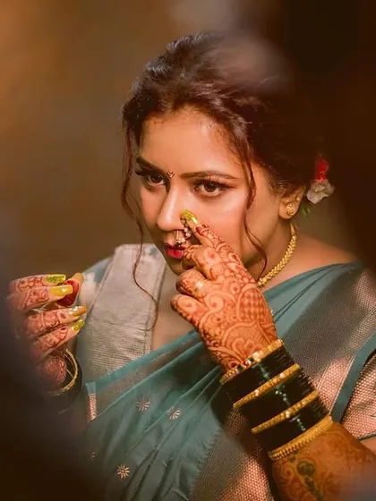 I love capturing these quiet, in between moments. Here is the beautiful Manali adjusting her Maharashtrian nath (nose ring), a final touch to her look. Her glowing skin and soft eye makeup look so elegant in this artistic shot.