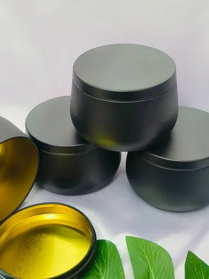 These matte black tin jars with a gold interior provide a sleek and modern container for your handmade candles. They are a stylish choice for creating a high-end candle line.