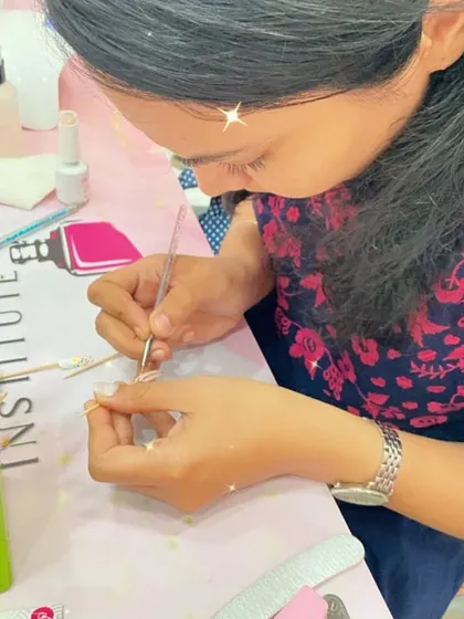 A student practices building the structure of a nail extension, a fundamental skill for any aspiring nail technician.