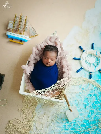 A different perspective of the newborn sailor theme, showing the intricate details of the props and the peaceful expression of the sleeping baby. We ensure every angle tells a part of the story.