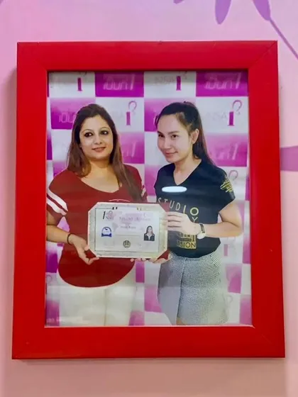 A photo of me receiving my certification. My training in Thailand allows me to offer you the latest and most advanced nail art techniques.