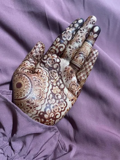 The stain on this intricate design came out so beautifully. The deep maroon color highlights every detail, from the central mandala to the delicate work on the fingers.