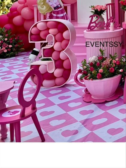 A close-up of the themed flooring with heart patterns, the marquee number '3', and a teacup flower pot.