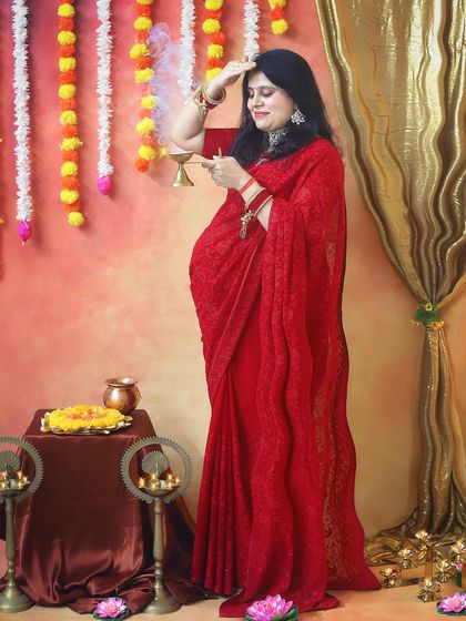 A beautiful pose capturing the mother-to-be offering prayers. The entire setup, with marigold garlands and brass diyas, is designed to celebrate our rich cultural heritage.