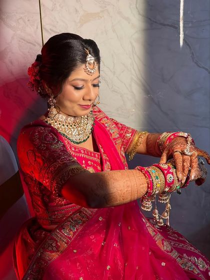 A classic wedding look blending tradition with a modern finish. This bride in her pink lehenga has soft tones and defined features for the perfect balance of grace and glam.