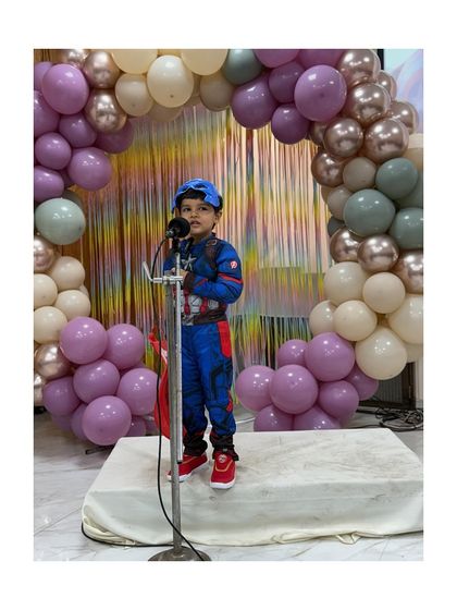 This young Captain America stands tall and proud, embodying the spirit of a hero.