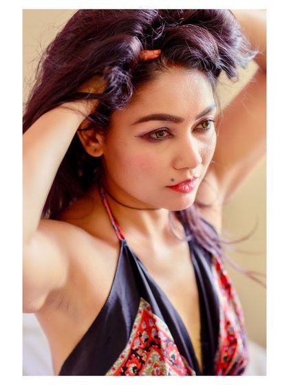 An intimate and candid-style portrait. The composition, looking in from the side, creates a sense of a private, stolen moment.