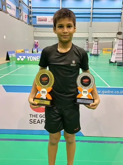 Mayuresh holding his U-13 Boys Doubles title trophy and U-13 singles runner-up trophy from the Yonex Sunrise Maharashtra State Badminton tournament.