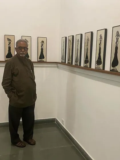 Artist S.G. Vasudev posing in front of Shakuntala Kulkarni's work at her solo show.
