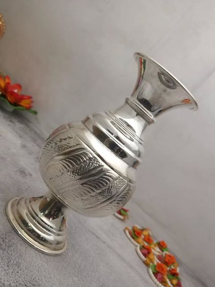 Another view of the German silver flower vase, perfect for holding a few stems of fresh flowers in your pooja room.