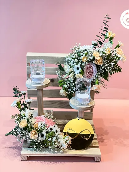 A full view of our rustic-chic ring platter, adorned with fresh flower bouquets in soft pink and white hues. It's a beautiful way to present the rings.