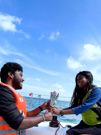 A romantic exchange of flowers between the happy couple after their mid-sea proposal.