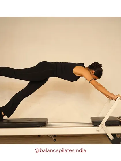 This long stretch on the reformer is a full-body exercise that builds strength in the shoulders, core, and legs, all while improving posture.