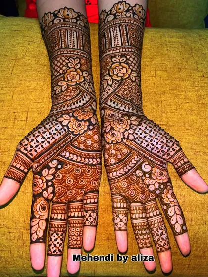 A full-hand floral design with intricate details. The roses and other flowers are shaded to give them a 3D effect.