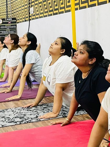 A close-up of our members practicing Bhujangasana, the cobra pose. This is a fundamental backbend that helps strengthen the spine and open the chest.