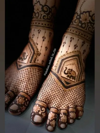 A close-up view of the delicate elephant and lotus motifs, showing the fine detail in this bridal foot design.