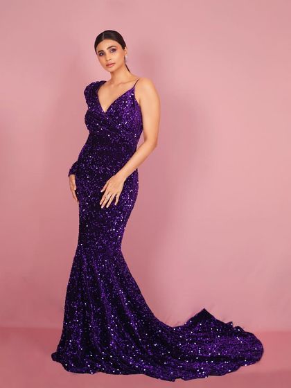 Another elegant pose from the same series, this image captures Daisy Shah in a classic stance that highlights both her poise and the gown's stunning design.