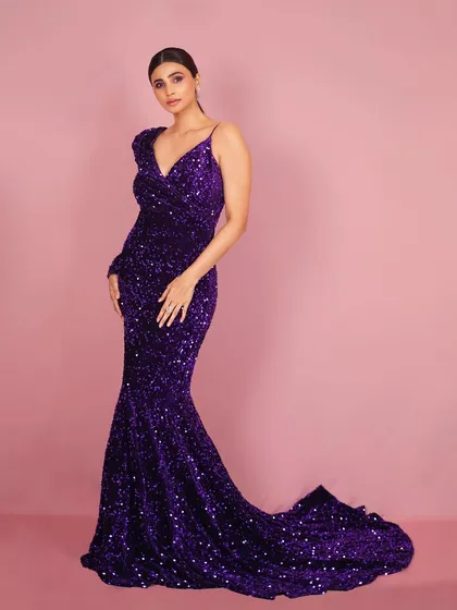 Another elegant pose from the same series, this image captures Daisy Shah in a classic stance that highlights both her poise and the gown's stunning design.
