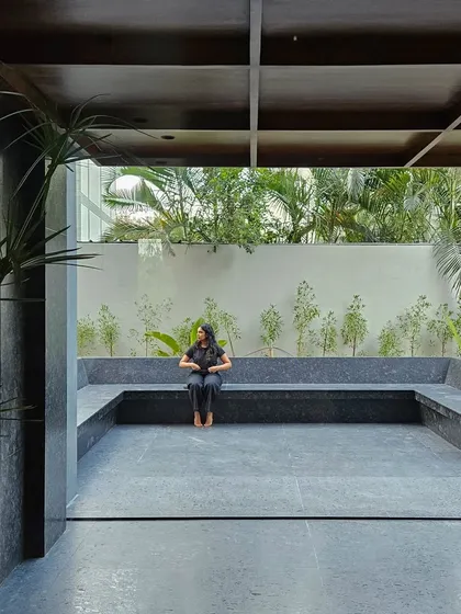 An outdoor breakout and seating area designed with black granite. This space serves as a tranquil extension of the office interior, providing a connection to nature for employees and visitors, embodying our approach to biophilic architecture.