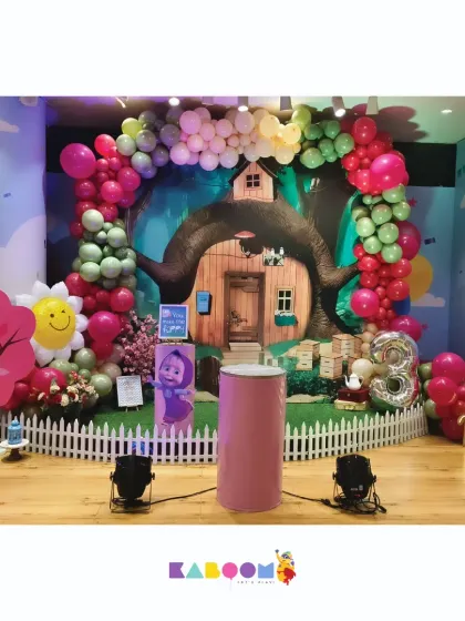 We brought the playful world of Masha and the Bear to this party with a forest-themed backdrop, character cutouts, and a colorful balloon arch.
