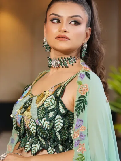 This angle shows the texture and detail of the sequined and embroidered blouse, paired with the elegant emerald choker. It’s a perfect blend of modern design and traditional elements.