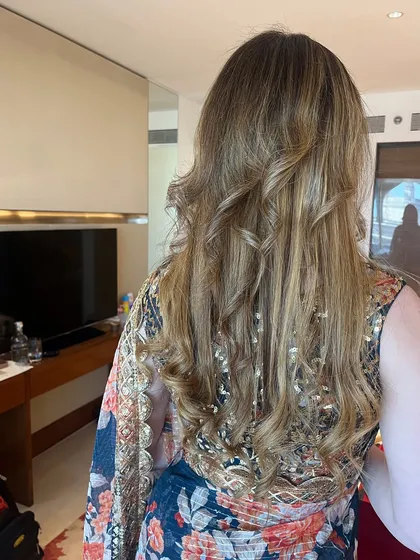 Soft waves and curls for my client Sonya. This hairstyle works beautifully with her hair color and adds a touch of glamour to her look.