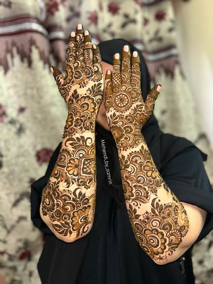 A beautiful design for a "Baat Pakki" ceremony. The floral patterns are bold and elegant, covering the hands and forearms for a celebratory look.
