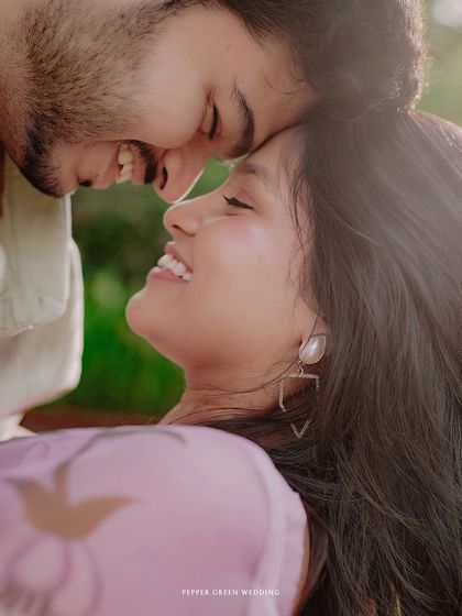 A soft, romantic close-up of Simran and Pranjal. The gentle light and their happy expressions create a dreamy and heartfelt image.