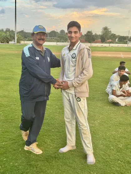 A handshake of appreciation for a U-19 player's hard work and success.