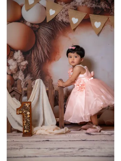 A full-length portrait of a girl in a pink dress, showing how elegant and sweet the boho theme can be.
