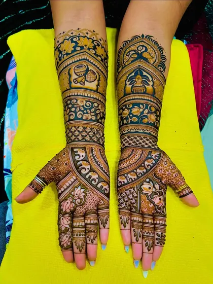 A rich and dense bridal design with a mix of floral and traditional motifs. The dark stain highlights the intricate details of the artwork.