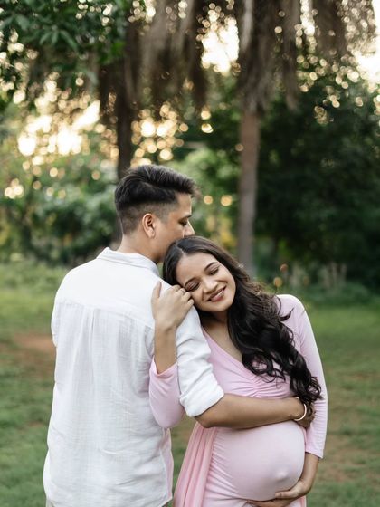 A quiet, intimate moment during their outdoor session. The way she rests her head on his shoulder is so sweet. The soft, natural light of the late afternoon makes this portrait feel warm and romantic.