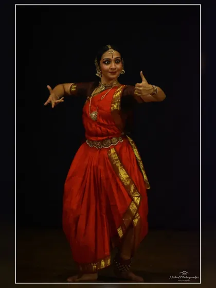 A gesture of calling or inviting, a common mudra used in abhinaya to communicate with other characters or the divine. This was captured during a solo recital.
